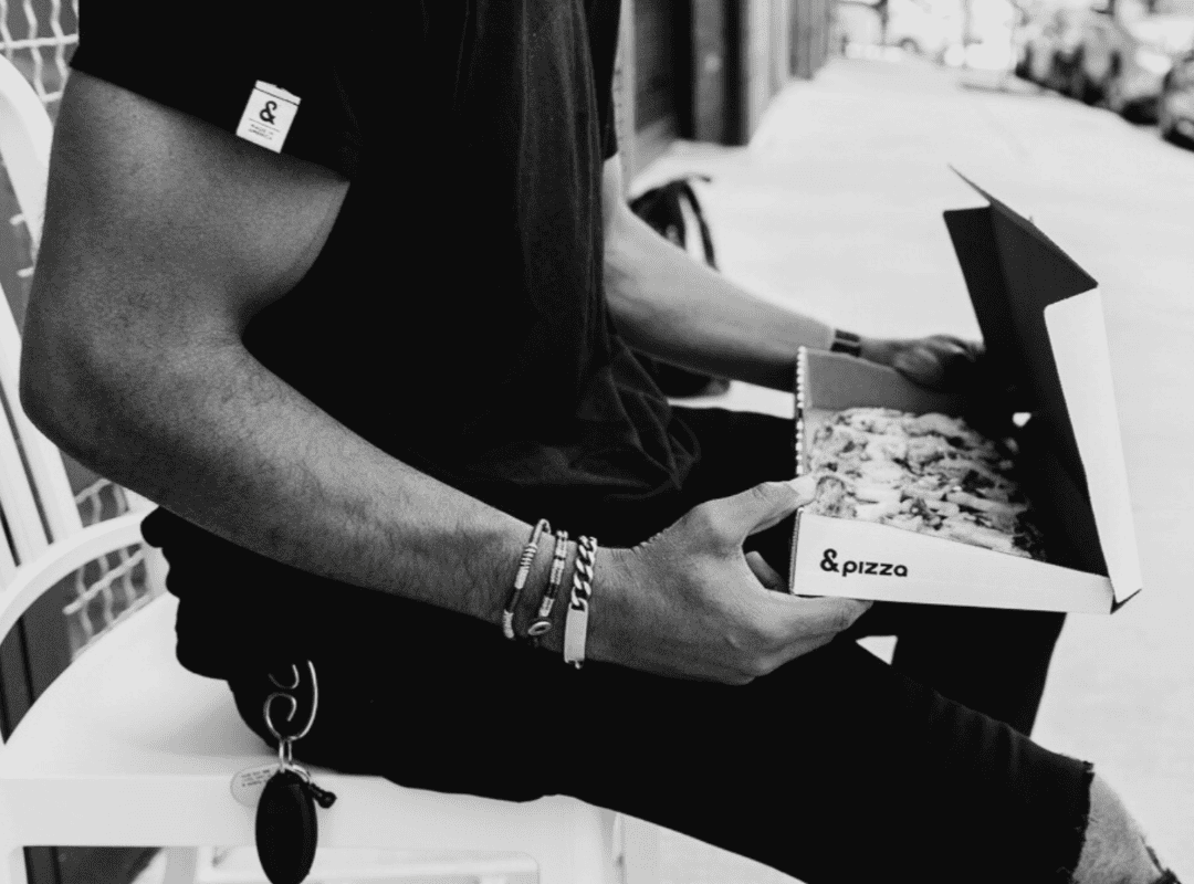 box outside fed1080x800 close up of man sitting outside with &pizza box open on his lap