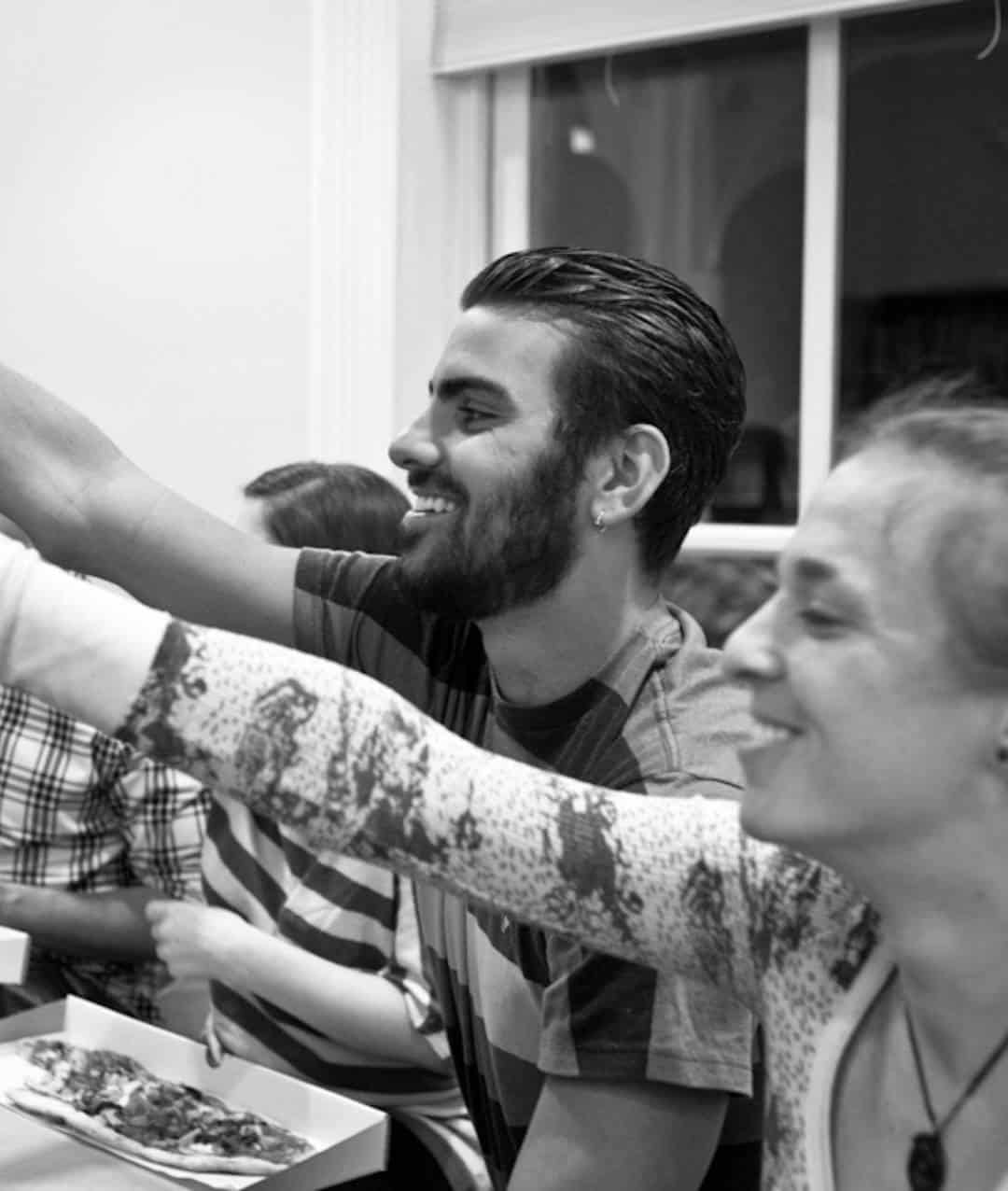 Friends sharing late night pizza together during a planned hangout.